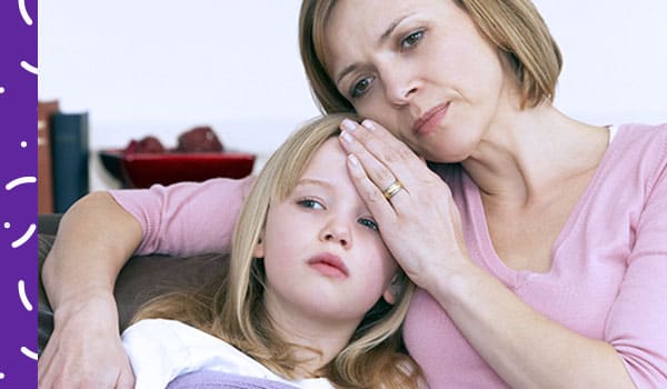 Woman feeling forehead of sick child.